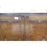 A vintage oak two door cupboard and a regency mahogany table on lion paw supports