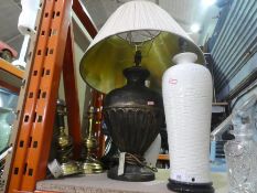 A pair of cream table lamps, another larger example and two brass lamps