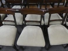 A set of eight Victorian mahogany arm chairs upholstered in cream fabric and including two carvers w