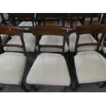 A set of eight Victorian mahogany arm chairs upholstered in cream fabric and including two carvers w