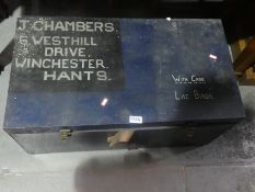 A wooden storage trunk, marked T. Chambers