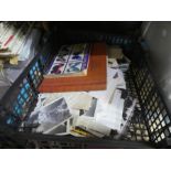 A tray of vintage ephemera and a crate of black and white photographs