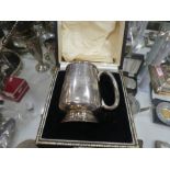 A mixed lot of silver items to include spoons, egg cup, napkin ring, decorative two handled cup and