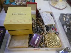 A tray of mixed costume jewellery including silver necklace, brooches, a boxed smartwatch etc