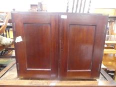 An antique mahogany brass bound cupboard with pigeon holes within