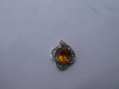 Pretty 9K yellow gold pendant with central Mandarin Citrine surrounded by white topaz., marked 375,