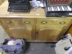 A Victorian stripped pine sideboards with two drawers and cupboard on turned supports