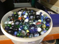 Container containing various vintage marbles