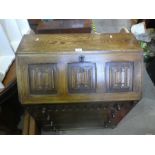 A carved oak bookcase with fitted interior above four drawers