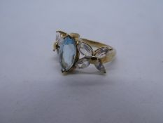 9ct yellow gold dress ring set with central blue topaz and floral set rainbow moonstones, marked 375