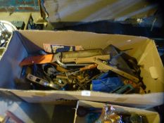 A box of various vintage tools including metal planes, saws, clamps etc