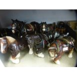 A collection of pottery Shire horses and accessories
