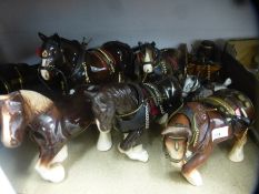 A collection of pottery Shire horses and accessories