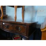 An inlaid mahogany serpentine front dressing table