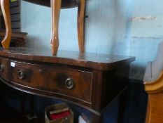 An inlaid mahogany serpentine front dressing table
