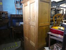 A Victorian wax pine two door paneled wardrobe