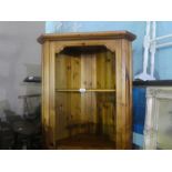 A waxed pine corner cupboard