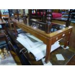 A retro oblong coffee table having tiled and a glass top