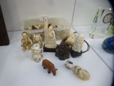 A collection of Oriental wooden and bone carved Netsuke to include figures, animals etc