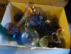 A crate of mixed coloured glassware including carnival vase and Murano fish