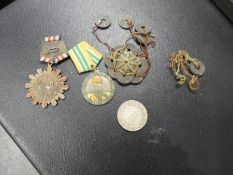 Selection of Chinese medals and a Chinese $1 coin