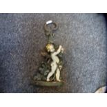 A vintage cast metal figural doorstop of a Cherub