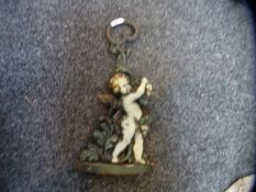 A vintage cast metal figural doorstop of a Cherub