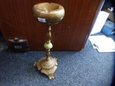 A pair of brass floor standing ashtrays