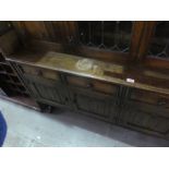 A large oak dresser with glazed doors above cupboard