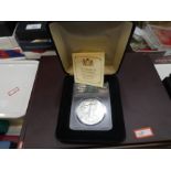 Two boxed coins, one being The Queen Victoria silver proof £5 coin 28.28g with certificates, other b