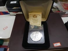 Two boxed coins, one being The Queen Victoria silver proof £5 coin 28.28g with certificates, other b