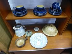 A collection of studio pottery including bee hive design cheese dish, candle sticks and a quantity o