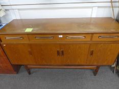A mid century teak side board with three drawers above cupboards by G plan