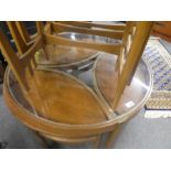 A 1960s G plan circular glass top table with three nesting tables