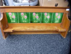 A vintage pine wall shelf inset with Art Noveau tiles