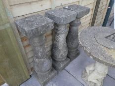 Large garden parasol on a cast iron stand and 3 stone effect plinths