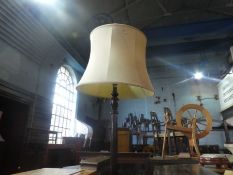 A mahogany standard lamp with shade