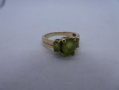9ct yellow gold dress ring set with three oval faceted peridot, size P/Q, gross weight 3.5g