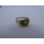 9ct yellow gold dress ring set with three oval faceted peridot, size P/Q, gross weight 3.5g