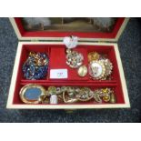 A musical jewellery box containing various necklaces, brooches, bracelets etc and a 9ct gold oval lo