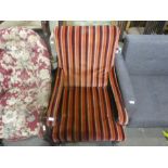 A Victorian mahogany framed nursing armchair upholstered in striped fabric
