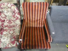 A Victorian mahogany framed nursing armchair upholstered in striped fabric
