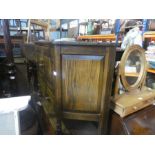 A carved oak panelled court cupboard