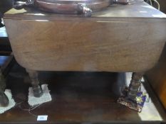 An antique mahogany drop flap coffee table