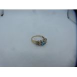 9ct yellow gold dress ring set with central oval aquamarine surrounded by diamond chips, size P/Q, m