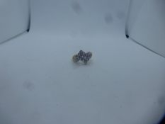 Pretty contemporary design ring inset with 12 small purple stones, marked 375, size O