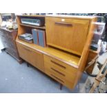 A 1970's teak sideboard with raised back on turned legs, 150 cms