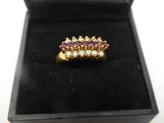 Pretty 18ct yellow gold dress ring, with 7 central rubies flanked by 12 diamonds marked 750, size Q,