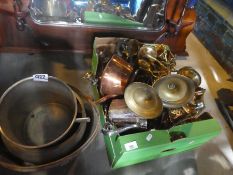 A box full of copper and brass items and large brass cooking pots