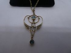 9ct yellow gold chain hung with a delicate pendant with aquamarine and seed pearl marked '9ct', pend